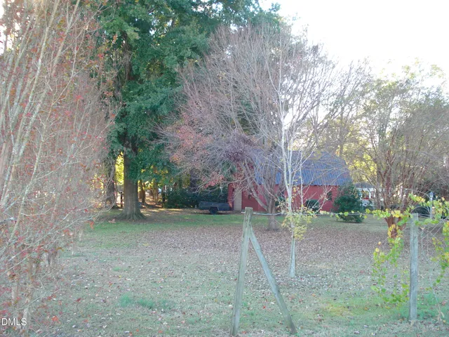 a view of a yard with large trees