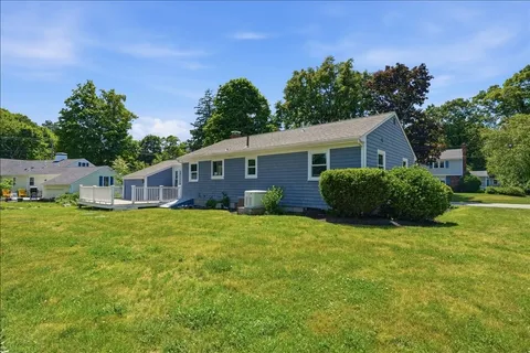 a view of a house with backyard and garden