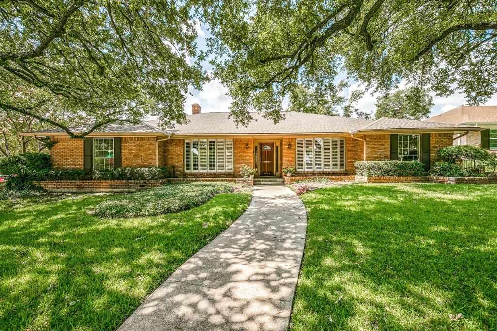 a front view of a house with a yard table and chairs