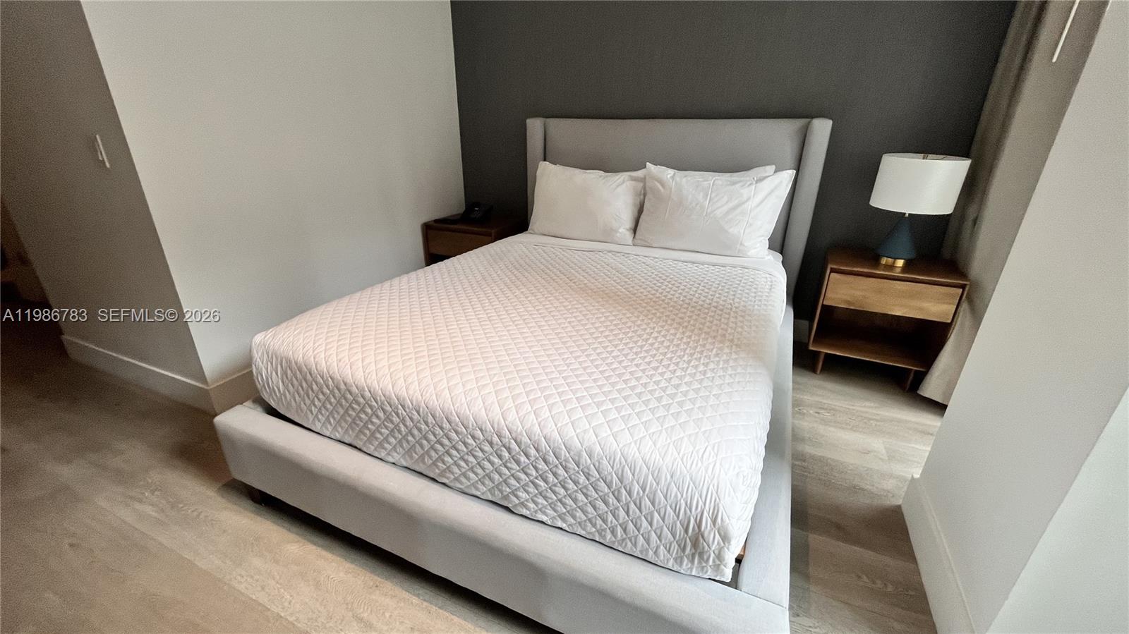 229 Southwest 9th Street, Unit 307 Miami, FL 33130 - Photo 11 of 36 a bedroom with a bed and a night stand