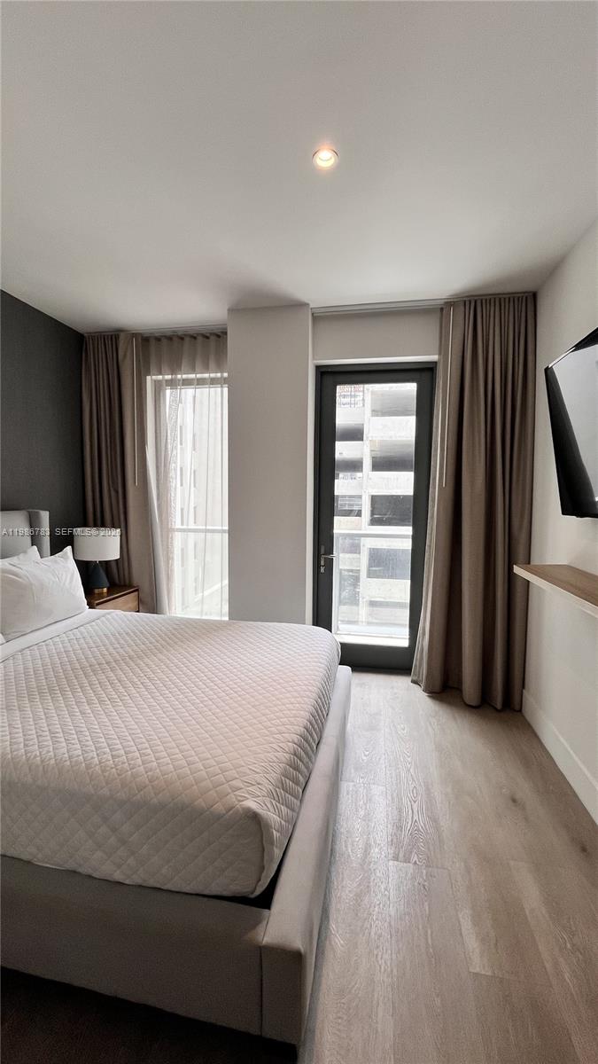 229 Southwest 9th Street, Unit 307 Miami, FL 33130 - Photo 13 of 36 a bedroom with a bed and a window