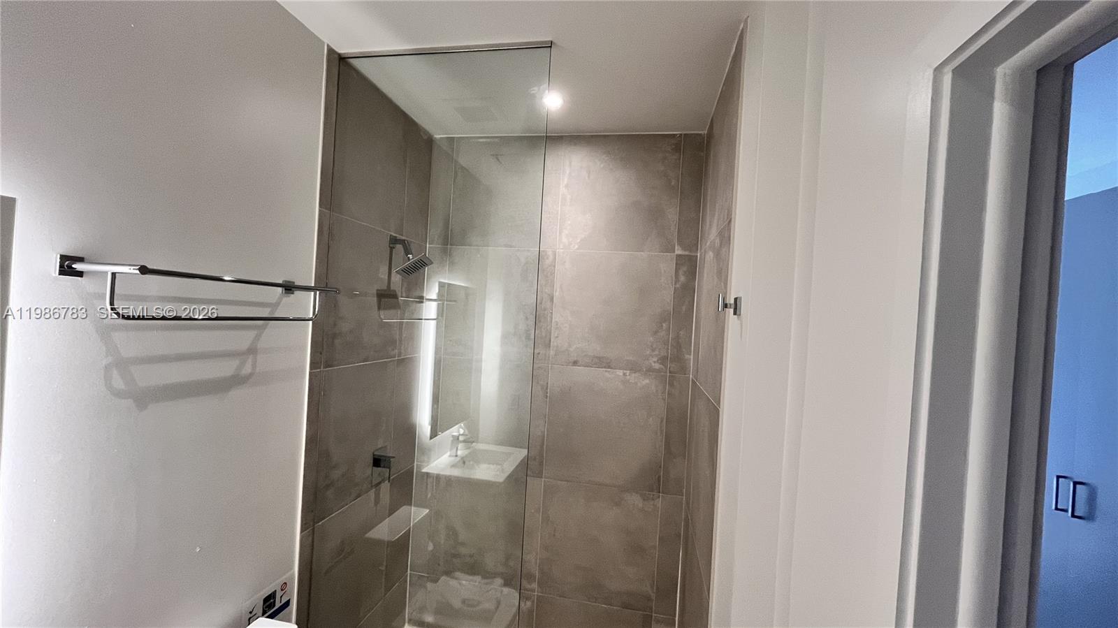 229 Southwest 9th Street, Unit 307 Miami, FL 33130 - Photo 15 of 36 a bathroom with a shower and a toilet