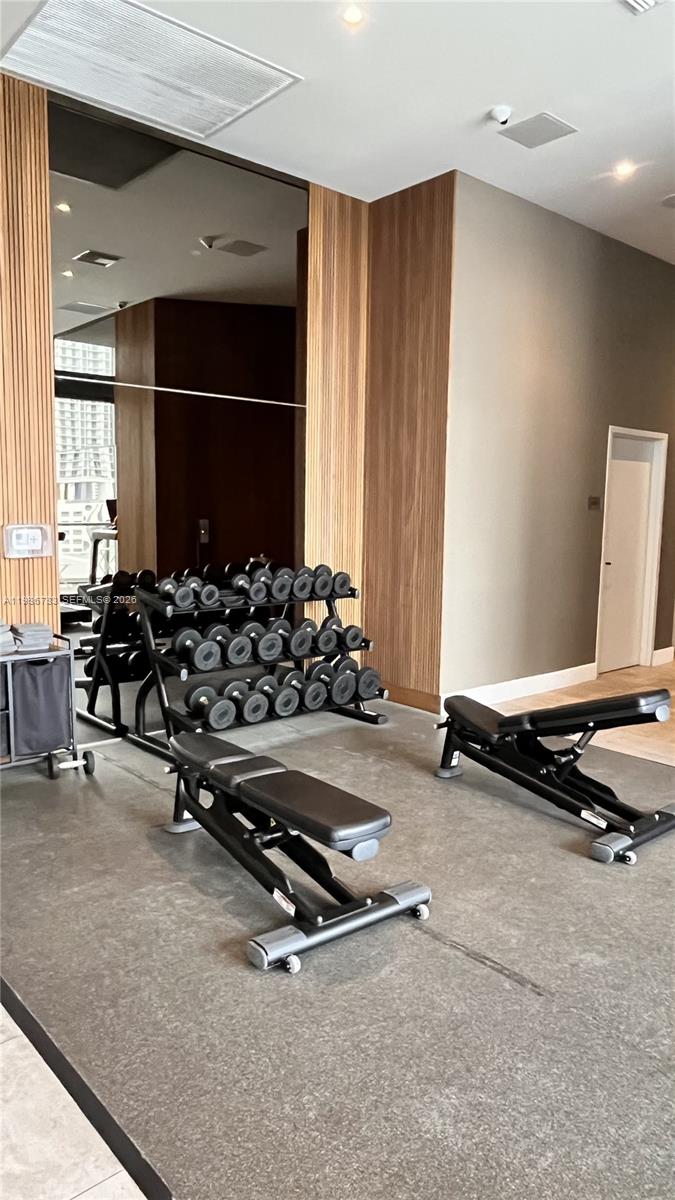 229 Southwest 9th Street, Unit 307 Miami, FL 33130 - Photo 23 of 36 a room with gym equipment and a large window