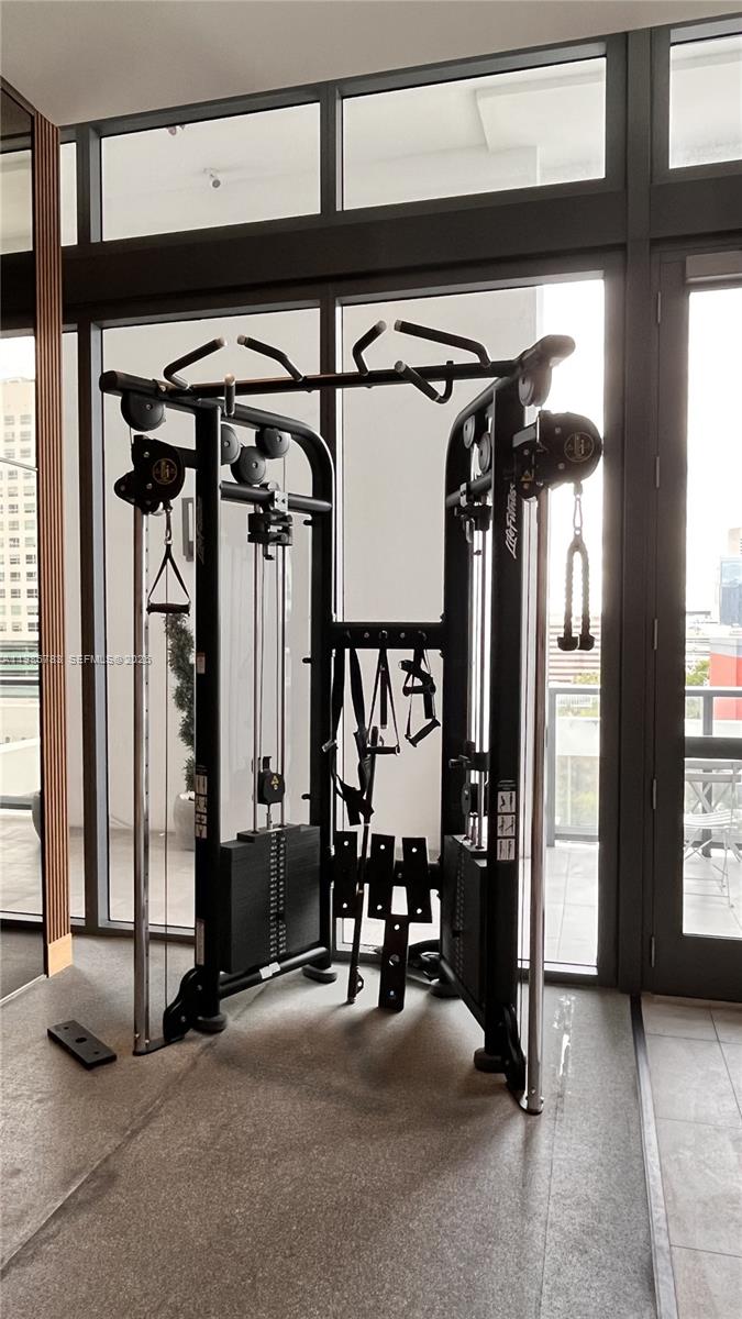 229 Southwest 9th Street, Unit 307 Miami, FL 33130 - Photo 25 of 36 a view of a hallway with glass door and furniture