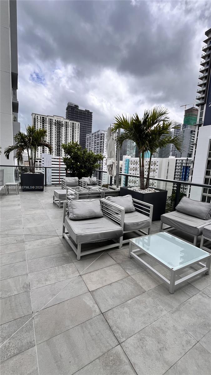 229 Southwest 9th Street, Unit 307 Miami, FL 33130 - Photo 36 of 36 a roof deck with couches and potted plants