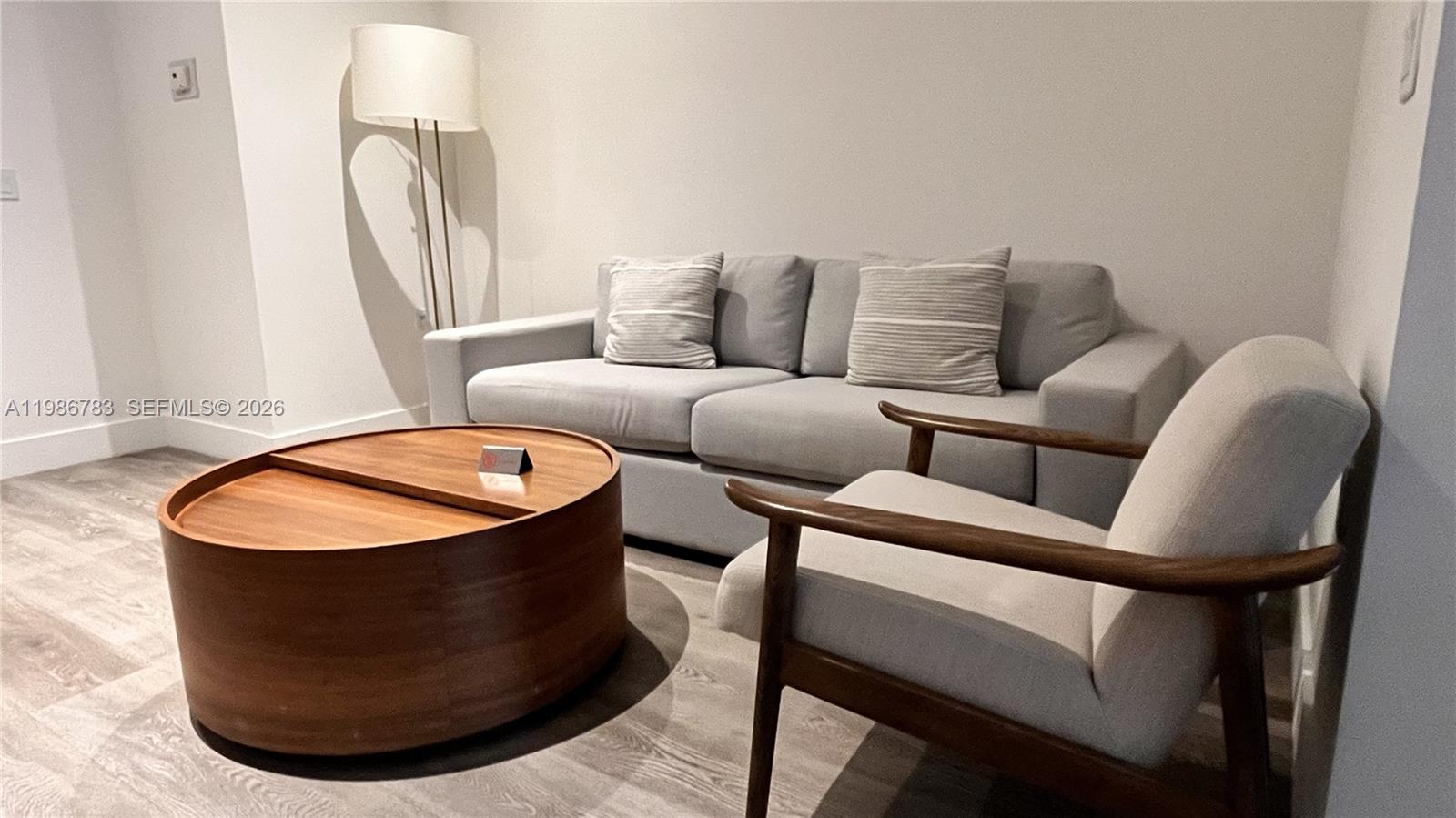 229 Southwest 9th Street, Unit 307 Miami, FL 33130 - Photo 5 of 36 a living room with furniture and a mirror