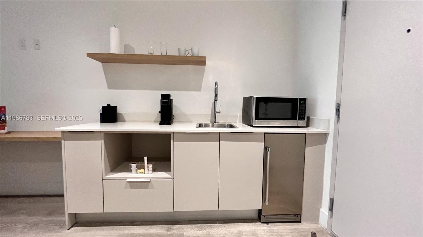 229 Southwest 9th Street, Unit 307 Miami, FL 33130 - Photo 6 of 36 a kitchen with cabinets and white appliances