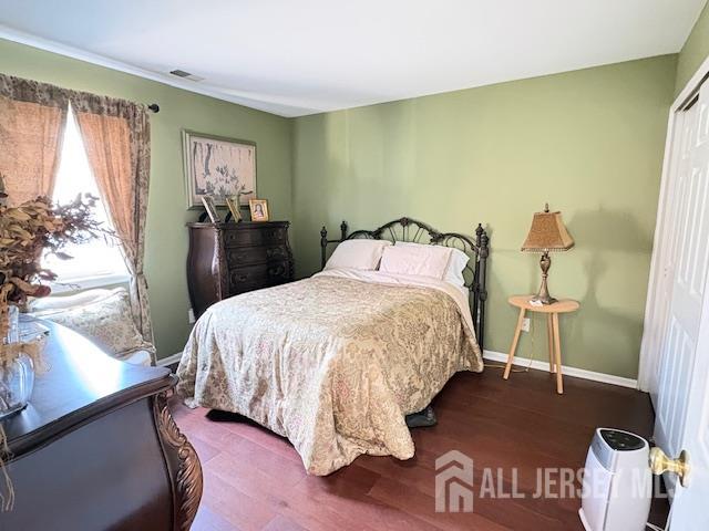 71B Winthrop Road Monroe Township, NJ 08831 - Photo 12 of 15 a bedroom with a bed and wooden floor