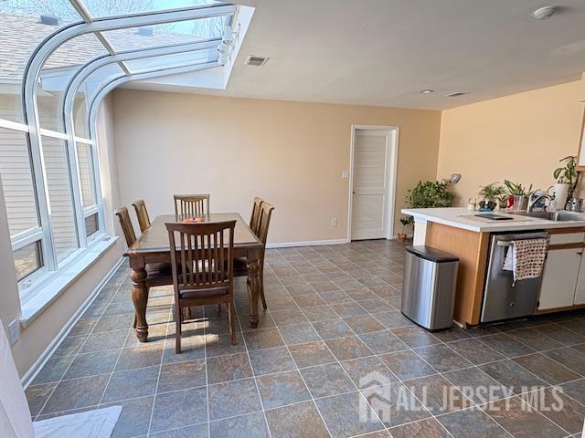 71B Winthrop Road Monroe Township, NJ 08831 - Photo 4 of 15 a dining room with a wooden table and chairs