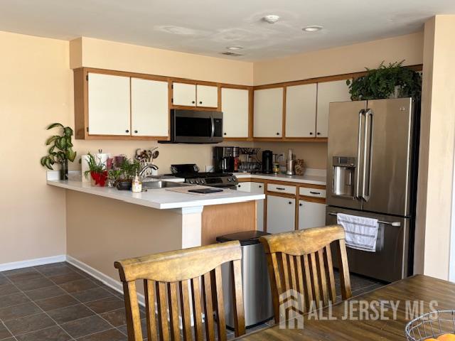 71B Winthrop Road Monroe Township, NJ 08831 - Photo 5 of 15 a kitchen with stainless steel appliances a microwave sink refrigerator and cabinets