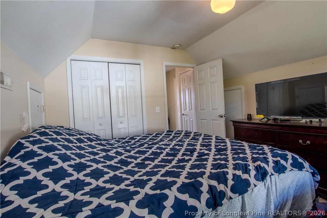 1629 Mattie Road Sanford, NC 27332 - Photo 15 of 29 a bedroom with a bed and a flat screen tv