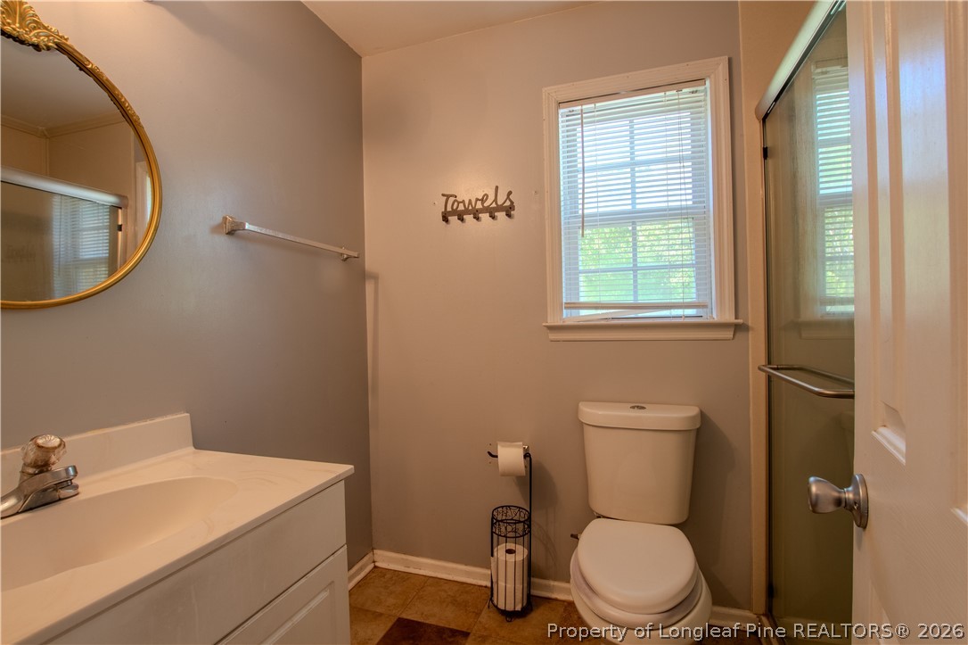 1629 Mattie Road Sanford, NC 27332 - Photo 18 of 29 a white toilet sitting next to a bathroom sink