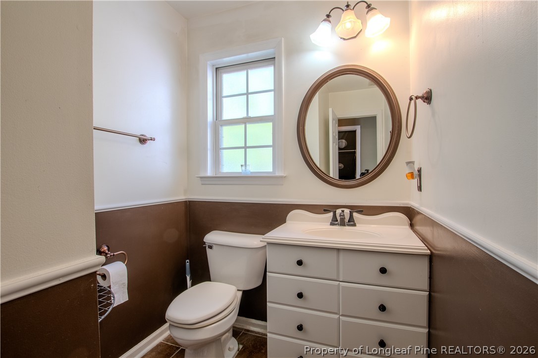 1629 Mattie Road Sanford, NC 27332 - Photo 19 of 29 a bathroom with a toilet sink and mirror