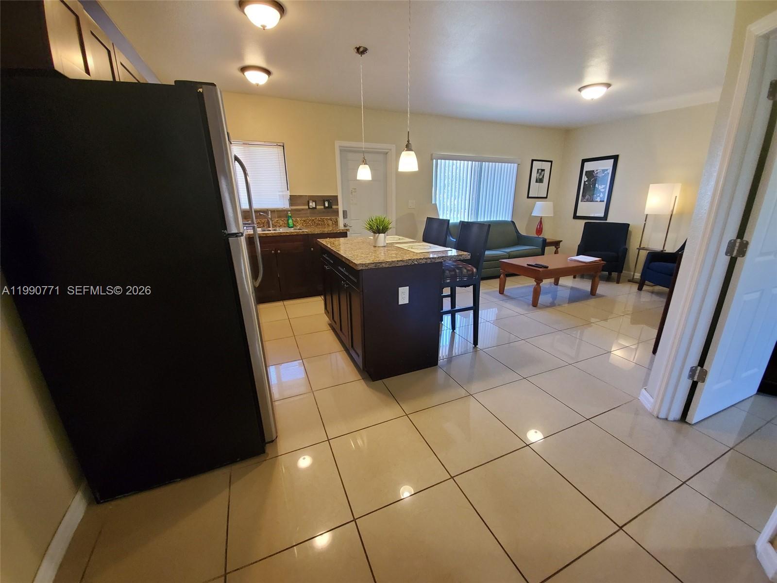 2015 Funston Street, Unit 2 Hollywood, FL 33020 - Photo 14 of 19 a living room with furniture a mirror a piano a sink and a counter top space