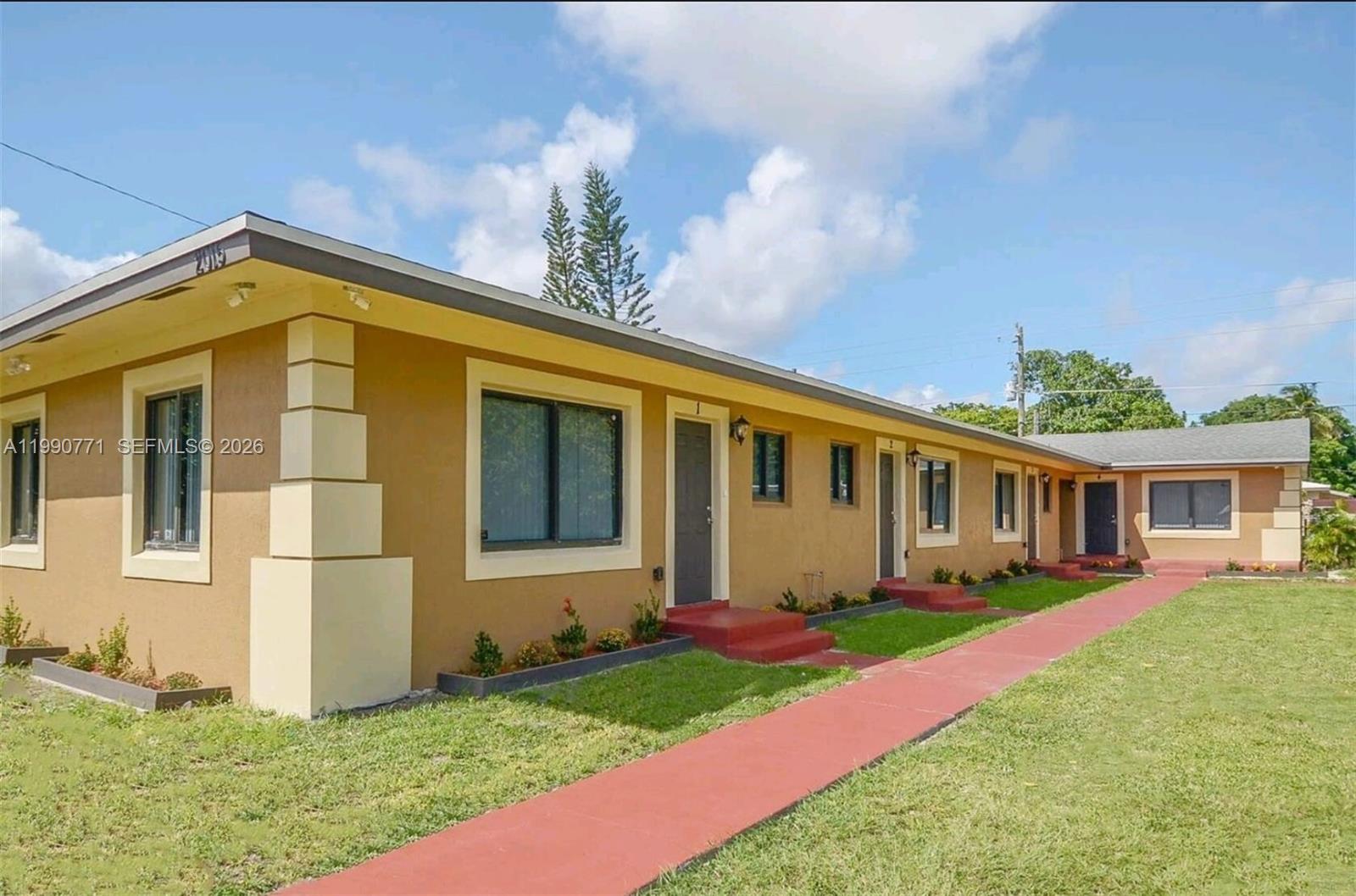 2015 Funston Street, Unit 2 Hollywood, FL 33020 - Photo 2 of 19 a front view of a house with a yard