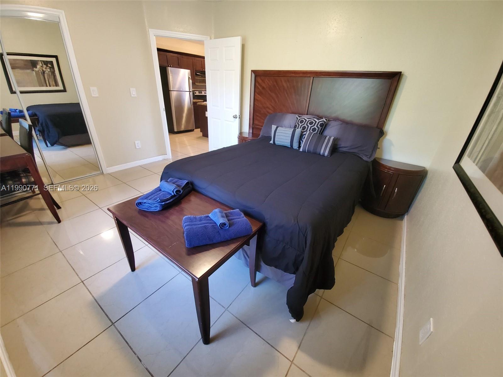 2015 Funston Street, Unit 2 Hollywood, FL 33020 - Photo 4 of 19 a bedroom with a bed and wooden floor