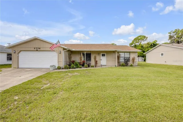 a front view of a house with a garden and yard