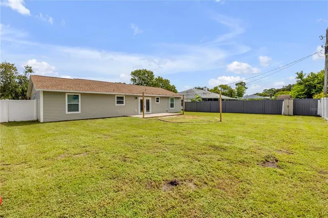 a house view with swimming pool in front of it