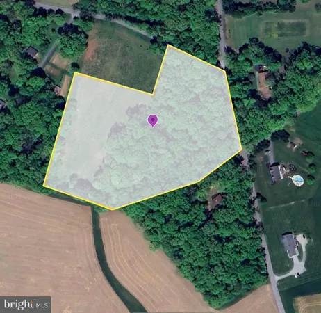 an aerial view of a house with a yard and lake view