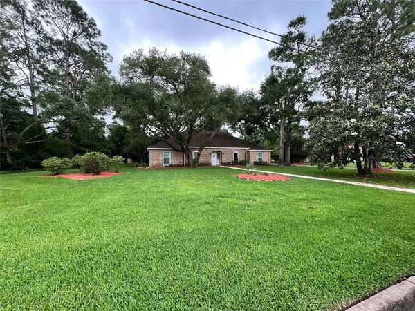 a view of a house with a yard and sitting area