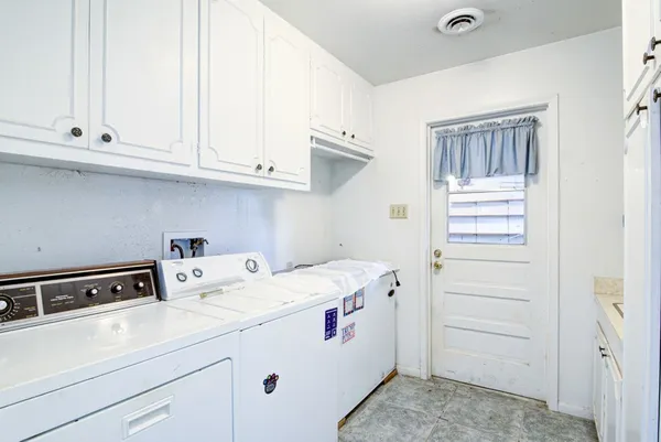 a view of backyard with wooden fence and trees