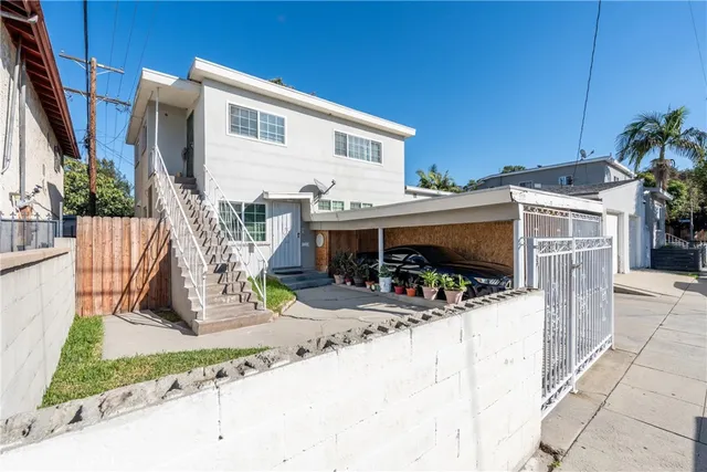 an aerial view of multiple houses with yard