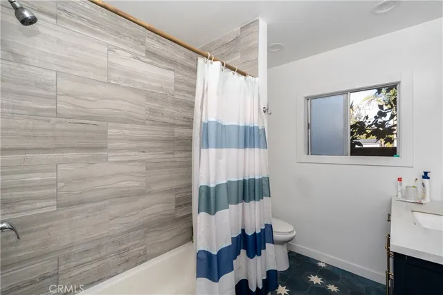 aerial view of a house with a garden and lake view