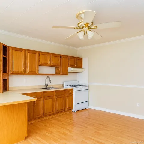 a view of a kitchen with a sink and a refrigerator