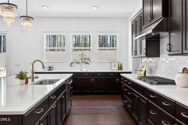 a kitchen with stainless steel appliances granite countertop a sink stove and cabinets
