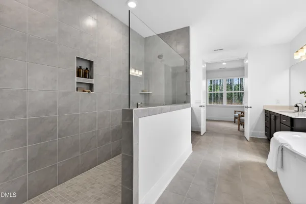 a bathroom with a granite countertop sink a toilet and shower