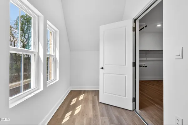 an empty room with window and ceiling fan