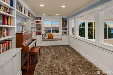 a living room with furniture and a book shelf