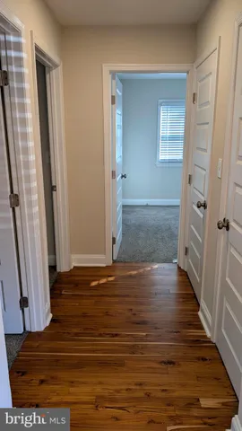 a view of a livingroom with wooden floor and staircase