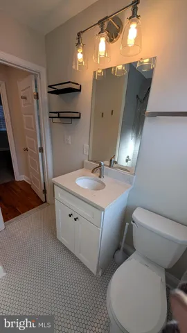 a bathroom with a toilet sink and mirror