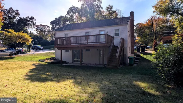 a view of a house with a yard covered with trees