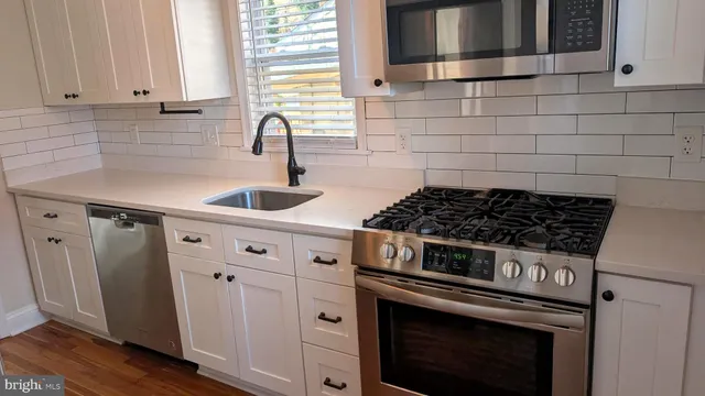 a kitchen with granite countertop a stove and a sink