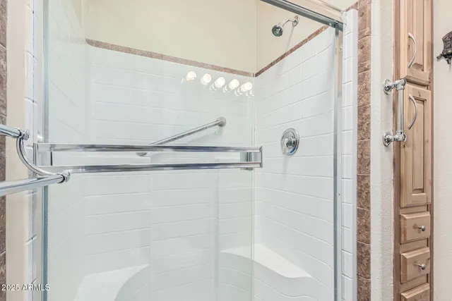 a bedroom with a bed and large window with balcony view