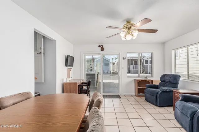 a living room with furniture a dining table and a window