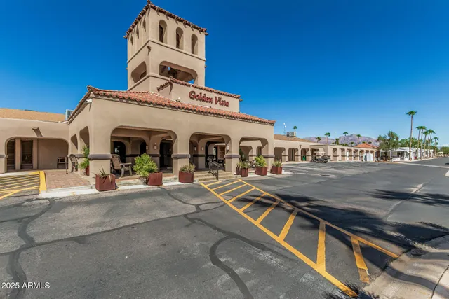 a view of a patio with a table and chairs