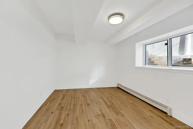 a view of a room with wooden floor and windows