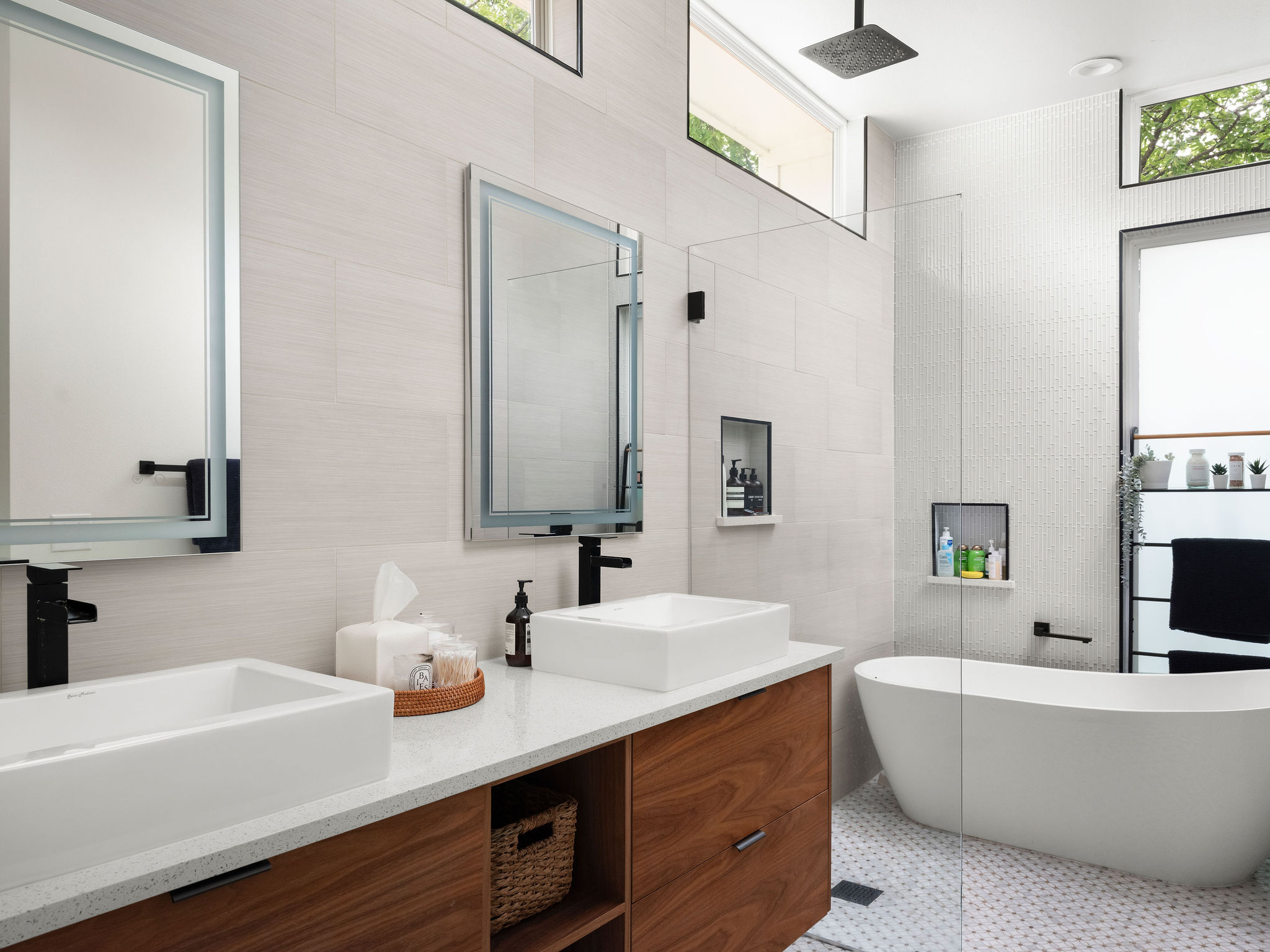 3710 Manorwood Road Austin, TX 78723 - Photo 19 of 40 Dual vessel sinks and a freestanding tub create a spa-like retreat in this well-appointed bathroom.