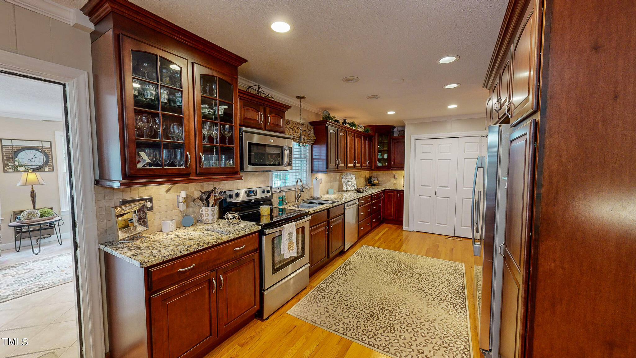 1804 Grady Drive Durham, NC 27712 - Photo 11 of 43 a large kitchen with stainless steel appliances granite countertop a large stove a sink and a refrigerator
