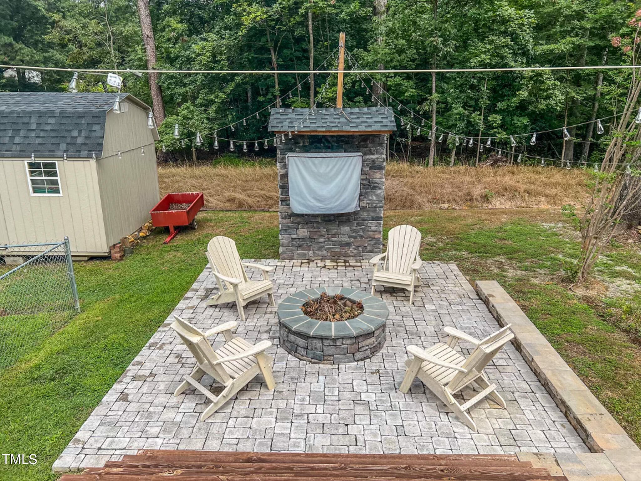 1804 Grady Drive Durham, NC 27712 - Photo 13 of 43 a backyard of a house with fireplace table and chairs
