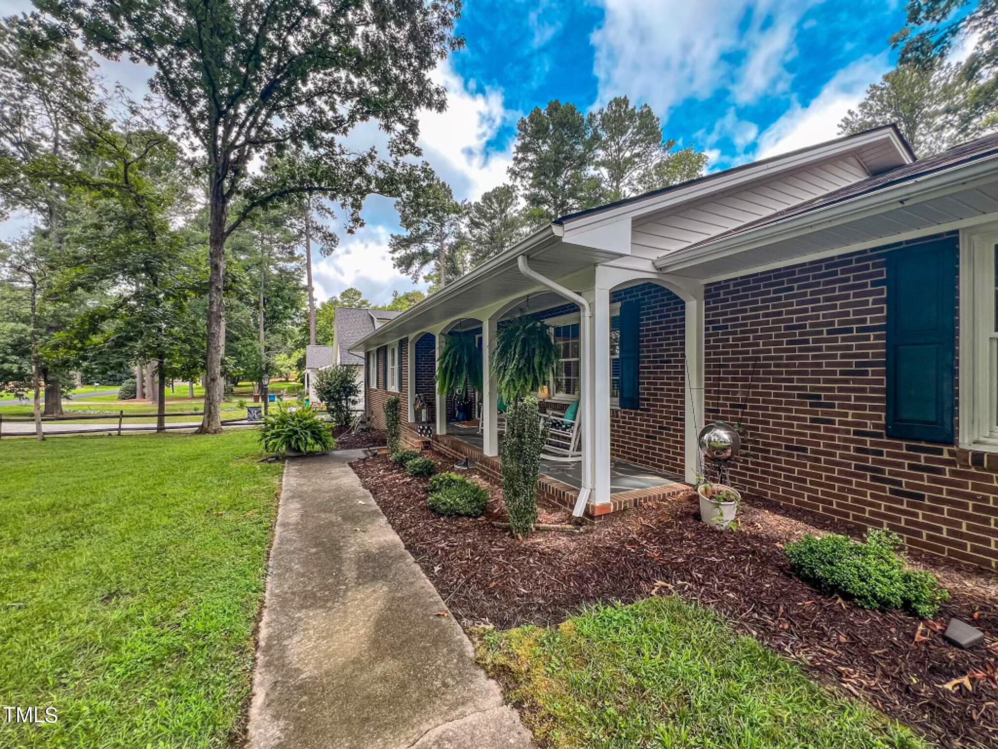 1804 Grady Drive Durham, NC 27712 - Photo 39 of 43 a view of a brick house with a large windows plants and large tree