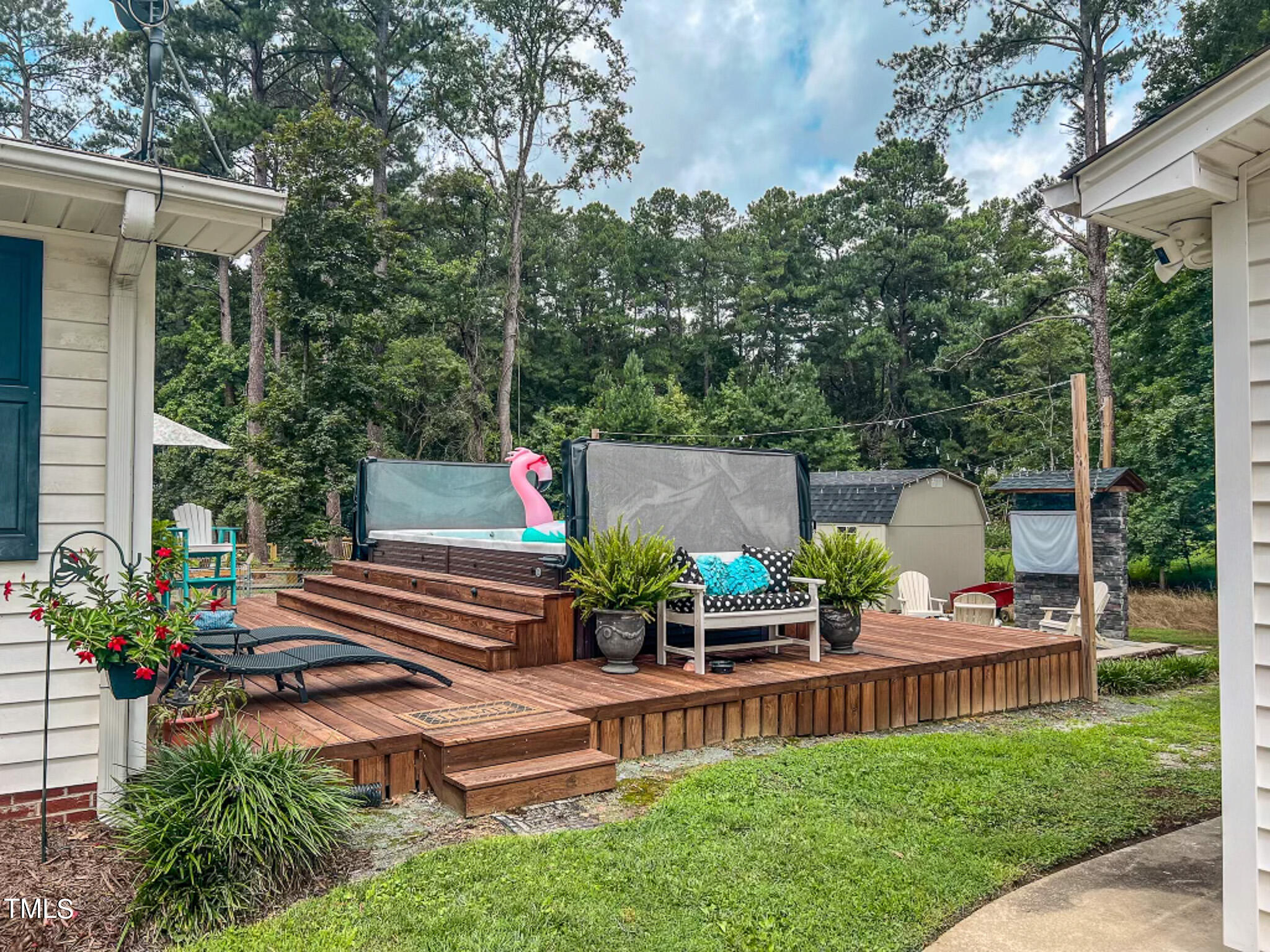 1804 Grady Drive Durham, NC 27712 - Photo 6 of 43 a view of a patio with table and chairs potted plants and large tree