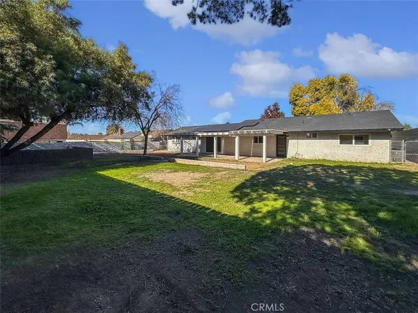 a view of a house with swimming pool next to a yard