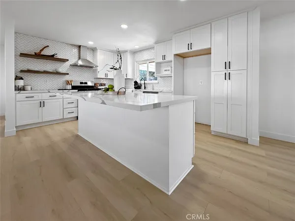 a kitchen with stainless steel appliances a refrigerator sink and cabinets