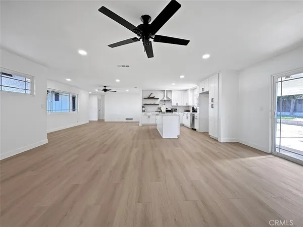 a view of kitchen and a sink with wooden floor