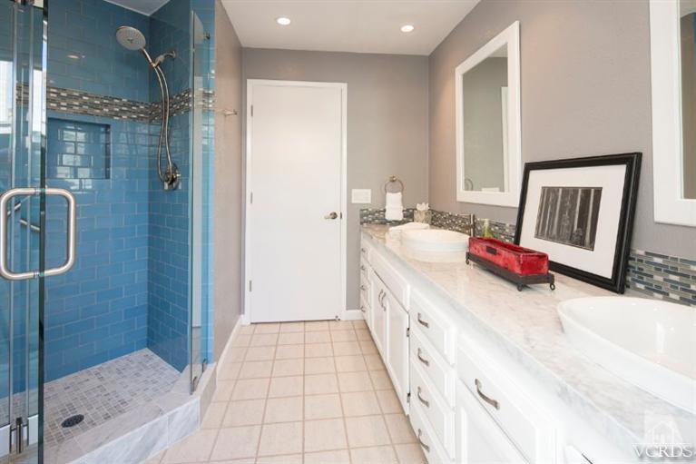 4025 Ocean Drive Oxnard, CA 93035 - Photo 13 of 31 a bathroom with a tub a sink and a mirror