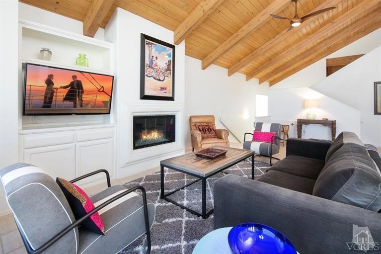 4025 Ocean Drive Oxnard, CA 93035 - Photo 19 of 31 a living room with furniture a flat screen tv and a fireplace